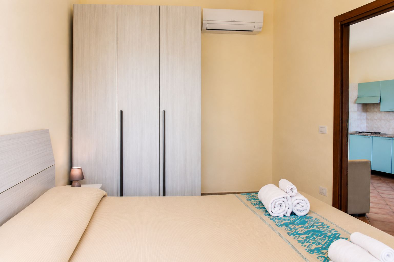 Bedroom and kitchen of the three-room apartment